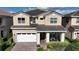Two-story house with tan exterior, white garage door, and landscaping at 9859 Winnington St, Orlando, FL 32832
