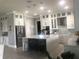 Modern kitchen with white cabinets, large island, and stainless steel appliances at 9859 Winnington St, Orlando, FL 32832