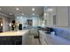 Modern kitchen with white cabinets, large island, and stainless steel appliances at 9859 Winnington St, Orlando, FL 32832