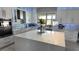 Modern kitchen with white cabinets, large island, and stainless steel appliances at 9859 Winnington St, Orlando, FL 32832
