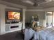 Main bedroom with fireplace, large TV, and sitting area at 9859 Winnington St, Orlando, FL 32832