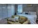 Main bedroom with plush bed and sitting area at 9859 Winnington St, Orlando, FL 32832