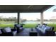 Relaxing patio overlooking a lake with wicker furniture at 9859 Winnington St, Orlando, FL 32832