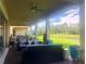 Covered patio with multiple ceiling fans and lake view at 9859 Winnington St, Orlando, FL 32832