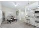 Bright dining area with glass table and four chairs, hardwood floors at 1333 Orchid Ave, Winter Park, FL 32789