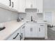 Modern white kitchen with hexagon tile backsplash and quartz countertops at 1333 Orchid Ave, Winter Park, FL 32789