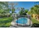 Oval pool with safety fence in grassy backyard at 1333 Orchid Ave, Winter Park, FL 32789