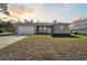 Newly constructed one-story home with gray siding, a white door, and a two-car garage at 2470 170Th Pl, Ocala, FL 34473