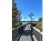 Wooden pier extending over lake, offering scenic views and relaxing atmosphere at 3398 Greenwich Village Blvd # 104, Orlando, FL 32835