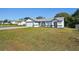 Landscaped lawn and freshly painted home with a two-car garage at 3407 Commerce Ave, Deltona, FL 32738