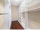 Large walk-in closet with custom shelving and hanging rods at 4232 Isle Vista Ave, Belle Isle, FL 32812