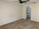 Bedroom with tiled floors, ceiling fan, and access to bathroom at 496 Raymond Ave, Longwood, FL 32750