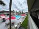 Refreshing swimming pool with red umbrellas and lounge chairs at 5245 W Irlo Bronson Memorial Hwy # 156, Kissimmee, FL 34746