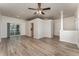 Bright living room featuring wood-look floors, a ceiling fan, and access to the backyard at 541 Willet Cir, Auburndale, FL 33823