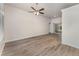 Spacious living room with wood-look flooring, ceiling fan, and sliding glass doors to the backyard at 541 Willet Cir, Auburndale, FL 33823