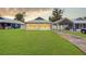 House exterior view, showing a well-maintained lawn and carport at 626 Nw 9Th Ave, Webster, FL 33597