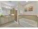 Bathroom boasts a soaking tub, shower, and granite vanity at 7383 Universal Blvd # 512, Orlando, FL 32819