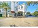 Resort-style building exterior with palm trees and parking at 7383 Universal Blvd # 512, Orlando, FL 32819