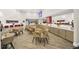 Community room with tables and chairs for residents at 7383 Universal Blvd # 512, Orlando, FL 32819