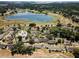 Aerial view of a community near a lake, showcasing the property's location and surrounding landscape at 1084 Villa Ln # 72, Apopka, FL 32712