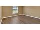 Bright bedroom featuring wood-look flooring and a window at 1084 Villa Ln # 72, Apopka, FL 32712