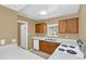 Galley-style kitchen with wood cabinets and modern appliances at 1084 Villa Ln # 72, Apopka, FL 32712
