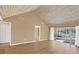 Living room with vaulted ceilings, wood-look floors and access to a patio at 1084 Villa Ln # 72, Apopka, FL 32712