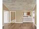 Open living area with a breakfast bar and wood-look floors at 1084 Villa Ln # 72, Apopka, FL 32712