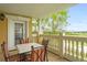 Private balcony with table and chairs, offering scenic golf course views at 1370 Centre Court Ridge Dr # 304, Kissimmee, FL 34747