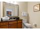 Bathroom with granite vanity, toilet, and a view into the kitchen at 1370 Centre Court Ridge Dr # 304, Kissimmee, FL 34747