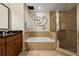 Bathroom with a bathtub, walk-in shower, and double sink vanity at 1370 Centre Court Ridge Dr # 304, Kissimmee, FL 34747