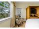 Bedroom with a comfortable armchair, balcony access, and a built-in TV at 1370 Centre Court Ridge Dr # 304, Kissimmee, FL 34747