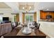 Elegant dining area with a chandelier and kitchen view at 1370 Centre Court Ridge Dr # 304, Kissimmee, FL 34747