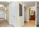 A bright hallway with tile floors, white doors, and access to a bathroom at 1370 Centre Court Ridge Dr # 304, Kissimmee, FL 34747