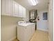 Laundry room with washer, dryer, and cabinets at 225 W Seminole Blvd # 206, Sanford, FL 32771