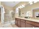 Bathroom with granite countertops, a walk-in shower, and double sinks at 2948 Banana Palm Dr, Kissimmee, FL 34747