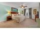 King-size bedroom with wood furniture and ceiling fan at 2948 Banana Palm Dr, Kissimmee, FL 34747