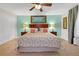 Large bedroom with king bed and ceiling fan at 2948 Banana Palm Dr, Kissimmee, FL 34747