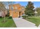 Two-story house with orange exterior, attached garage, and landscaped lawn at 2948 Banana Palm Dr, Kissimmee, FL 34747