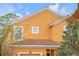 Orange two-story house with tile roof and white trim at 2948 Banana Palm Dr, Kissimmee, FL 34747