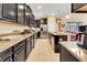 Modern kitchen with dark cabinets, granite counters, and stainless steel appliances at 2948 Banana Palm Dr, Kissimmee, FL 34747