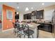 Modern kitchen with dark wood cabinets, granite countertops and an island at 2948 Banana Palm Dr, Kissimmee, FL 34747