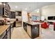 Open kitchen with dark cabinetry, stainless steel appliances, and an island at 2948 Banana Palm Dr, Kissimmee, FL 34747