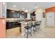 Modern kitchen with dark wood cabinets, granite countertops, and an island at 2948 Banana Palm Dr, Kissimmee, FL 34747