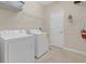 Laundry room with washer, dryer, and shelving at 2948 Banana Palm Dr, Kissimmee, FL 34747