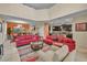 Spacious living room with high ceilings, red sofas, and a large TV at 2948 Banana Palm Dr, Kissimmee, FL 34747