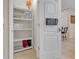 White shelving unit with storage for linens and other household items at 2948 Banana Palm Dr, Kissimmee, FL 34747