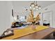 Dining area with long wooden table and view into living room at 3205 Gold Ln, Kissimmee, FL 34747