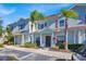 Front view of a light blue townhome with landscaping and parking at 3205 Gold Ln, Kissimmee, FL 34747