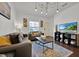 Living room with gray sofa, coffee table, and large TV at 3205 Gold Ln, Kissimmee, FL 34747